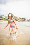 Girl wearing bikini running in sea, Los Angeles, California, USA