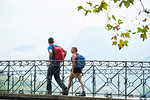 Man and young woman strolling along river footbridge, portrait, Annecy, Rhone-Alpes, France