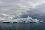 Iceberg under cloudy sky, Vibebukta, Austfonna, Nordaustlandet, Svalbard, Norway