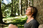Woman relaxing in forest, Sonthofen, Bayern, Germany