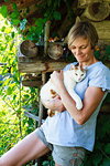 Woman carrying cat in countryside