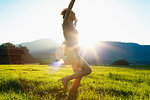 Woman dancing on grass in countryside, Sonthofen, Bayern, Germany