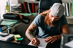 Small business owner doing paperwork in office