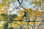 Child on high rope course, Paris, Ile-de-France, France