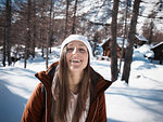 Young woman in knit hat in snow covered forest, portrait, Alpe Ciamporino, Piemonte, Italy