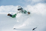 Male skier speeding down snow covered mountain, Alpe-d'Huez, Rhone-Alpes, France