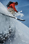 Male skier skiing mid air down steep snow covered mountain, Alpe-d'Huez, Rhone-Alpes, France