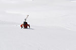 Male skier trudging up mountain through deep snow, Alpe-d'Huez, Rhone-Alpes, France