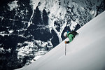 Male skier skiing down steep mountainside, Alpe-d'Huez, Rhone-Alpes, France