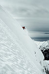 Male skier speeding down steep mountainside, Alpe-d'Huez, Rhone-Alpes, France