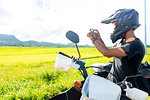 Motorcyclist stopping to take photograph, Camalaniugan, Cagayan, Philippines