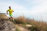 Runner jogging on cliff top, Santa Barbara, California, USA