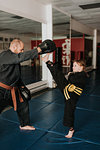 Coach and student practising kickboxing in studio