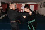 Couple practising martial arts in studio