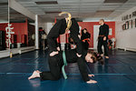 Coach and students practising martial arts in studio