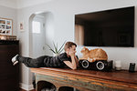 Boy staring at cat on cabinet