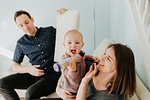 Mid adult couple on sofa with baby son