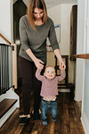 Mother walking baby son in hallway