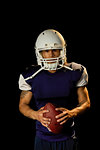 Portrait of football player, black background