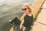 Young woman relaxing by river in summer