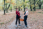 Best friends collecting chestnuts, Rezzago, Lombardy, Italy