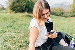 Woman texting on grass
