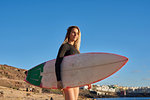 Surfer with surfboard on beach