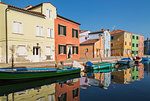 Moored green and blue boats on canal lined with colourful stucco houses, Burano Island, Venetian Lagoon, Venice, Veneto, Italy