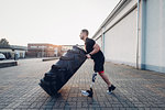 Man with prosthetic leg weight training with giant tyre