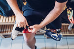 Man with prosthetic leg in gym changing room