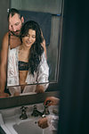 Semi-naked hipster couple washing hands in bathroom