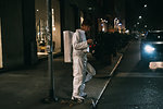 Astronaut using smartphone on pavement