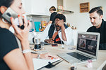 Businessmen and businesswoman using smartphone in loft office