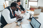 Businessmen using smartphone in loft office