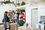 Friends talking at party in loft office