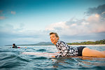 Surfer gliding in sea at sunset, Pagudpud, Ilocos Norte, Philippines