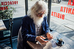 Senior businessman using digital tablet in cafe, Milano, Lombardia, Italy