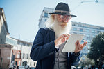Senior businessman using digital tablet in city, Milano, Lombardia, Italy
