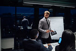 Businessman using digital tablet during office presentation