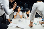 Businessmen and women having discussion over conference table meeting