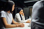 Businesswomen listening at conference table meeting