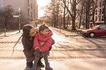 Mother and daughter on pavement