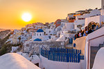 View of traditional blue domed churches and white houses at sunset in Oia, Santorini, Cyclades, Aegean Islands, Greek Islands, Greece, Europe