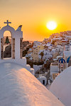View of traditional blue domed churches and white houses at sunset in Oia, Santorini, Cyclades, Aegean Islands, Greek Islands, Greece, Europe