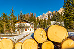 Logs by house in snow in Carezza, Italy, Europe
