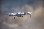 Drone (unmanned aerial vehicle) flying mid air, shallow focus