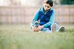 Girl playing with puppy on grass