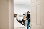 Girl jumping from bed into father's arms