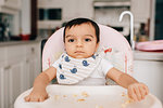 Cute baby boy sitting in high chair, portrait