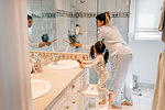 Girl and mother getting ready in bathroom